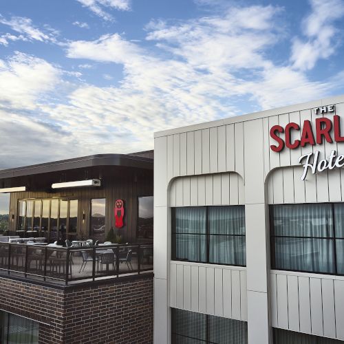 The exterior of The Scarlet Hotel with a big &ldquo;SCARLET&rdquo; sign under a bright blue sky.